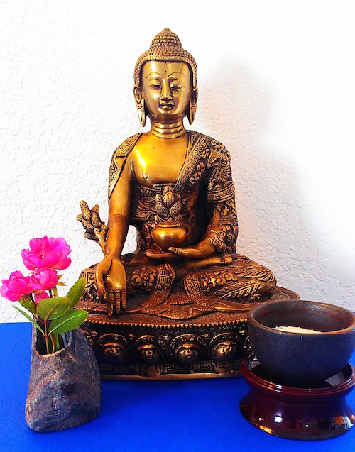 Menla statue with flower and bowl